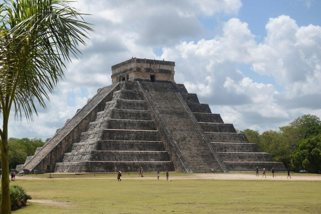 a group of people standing in front of a pyramid